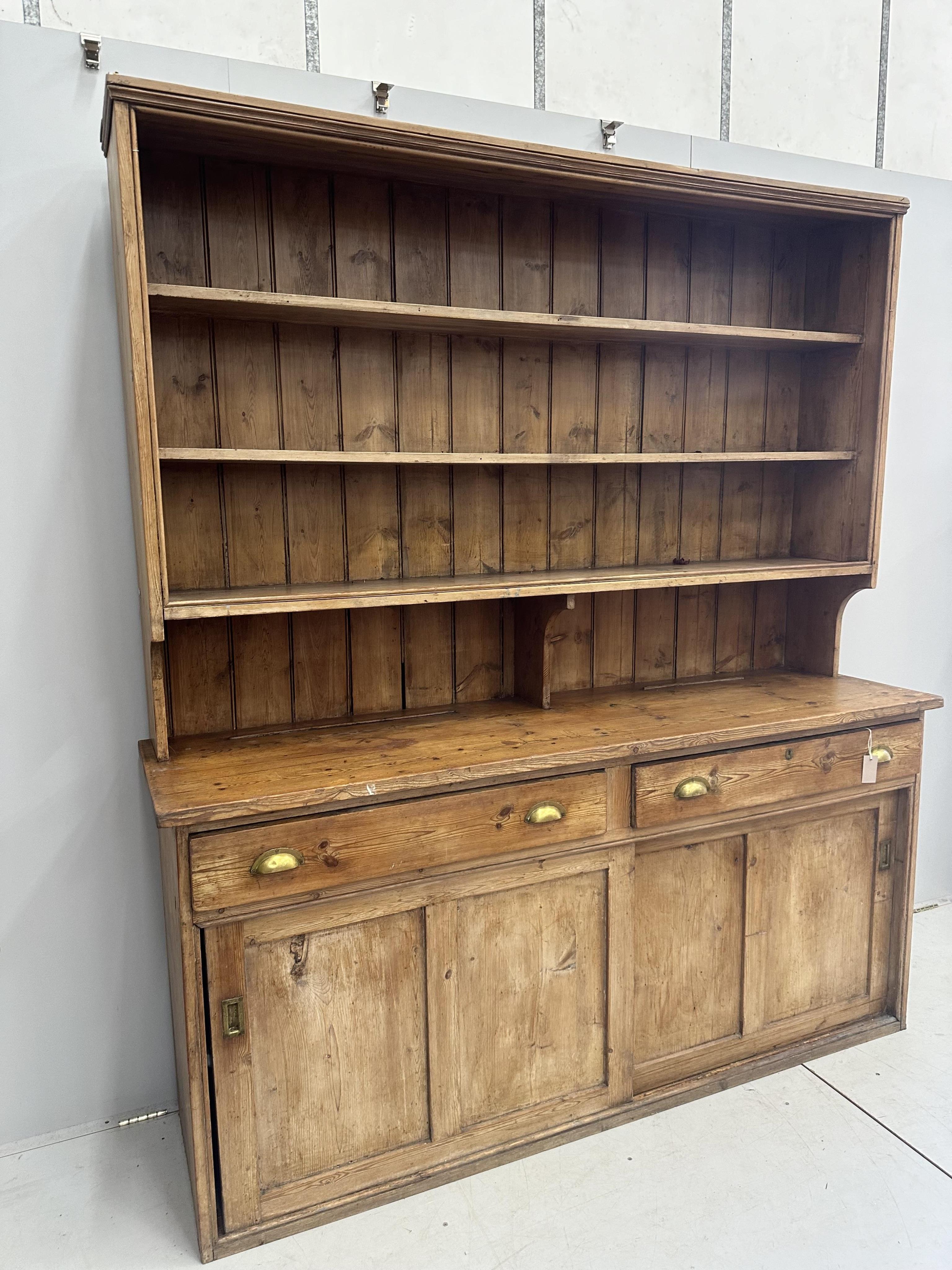 A Victorian pine dresser with boarded rack, width 189cm, depth 51cm, height 216cm. Condition - poor to fair